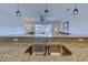 Granite countertops, double stainless steel sink, and an open view to the living room, enhance this modern kitchen at 202 Landing Rd. # B, North Myrtle Beach, SC 29582