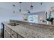 Open-concept kitchen features granite countertops and seamlessly connects to the inviting living space at 202 Landing Rd. # B, North Myrtle Beach, SC 29582