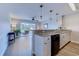 Modern kitchen featuring granite countertops, a breakfast bar, and an open view to the living area at 202 Landing Rd. # B, North Myrtle Beach, SC 29582