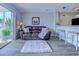 Comfortable living room with leather sofa, shag rug, bar seating and a sliding door to the outside at 202 Landing Rd. # B, North Myrtle Beach, SC 29582