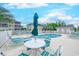 Community pool featuring ample seating, lounge chairs, umbrellas and palm trees at 202 Landing Rd. # B, North Myrtle Beach, SC 29582