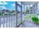 This screened porch has a view of community landscaping and nearby buildings at 202 Landing Rd. # B, North Myrtle Beach, SC 29582