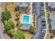 Aerial shot of the community pool surrounded by palm trees, lounge chairs, and lush landscaping at 2037 Silvercrest Dr. # 16E, Myrtle Beach, SC 29579