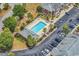 Aerial shot of the community pool surrounded by palm trees, lounge chairs, and lush landscaping at 2037 Silvercrest Dr. # 16E, Myrtle Beach, SC 29579