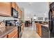 Open kitchen features black appliances and a seamless transition to the living room at 2037 Silvercrest Dr. # 16E, Myrtle Beach, SC 29579