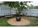Backyard fire pit area with gravel, landscaping, seating, and white fencing at 2039 Chadbury Ln., Myrtle Beach, SC 29588