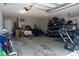 Garage with lawn equipment, bikes and storage shelves at 2039 Chadbury Ln., Myrtle Beach, SC 29588