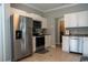 Modern kitchen with stainless steel appliances, white cabinets, and tile flooring at 2039 Chadbury Ln., Myrtle Beach, SC 29588