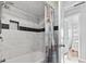 Stylish bathroom with a tiled shower, decorative accents, and a view to the bedroom at 210 16Th Ave. N, Surfside Beach, SC 29575