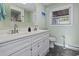 Bright bathroom with double sinks, a modern vanity, and sleek black tile floors at 210 16Th Ave. N, Surfside Beach, SC 29575