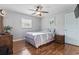 This bedroom has wood floors, a ceiling fan, and is naturally lit at 210 16Th Ave. N, Surfside Beach, SC 29575