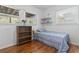 Charming bedroom featuring hardwood floors, a bookshelf, and natural light from multiple windows at 210 16Th Ave. N, Surfside Beach, SC 29575