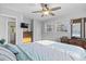 Inviting bedroom with large bed, wooden dresser, ceiling fan, and abundant natural light at 210 16Th Ave. N, Surfside Beach, SC 29575