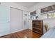 Bright bedroom with hardwood floors, a closet, and a bookshelf, offering ample storage at 210 16Th Ave. N, Surfside Beach, SC 29575