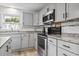Updated kitchen with white cabinets, granite countertops, stainless steel appliances, and wood-look flooring at 210 16Th Ave. N, Surfside Beach, SC 29575