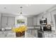 Bright kitchen features gray cabinets, granite countertops, and stainless steel appliances at 210 16Th Ave. N, Surfside Beach, SC 29575