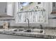 Stainless steel sink with window featuring patterned valance, and gray-toned countertop at 210 16Th Ave. N, Surfside Beach, SC 29575