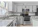 Renovated kitchen showcasing stainless steel appliances, granite counters, and ample cabinet space at 210 16Th Ave. N, Surfside Beach, SC 29575