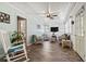 Cozy living room offering ample seating, wood-paneled ceiling, and access to other rooms at 210 16Th Ave. N, Surfside Beach, SC 29575