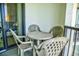 Intimate balcony with seating area, offering a peek into the stylish bedroom at 2101 S Ocean Blvd. S # B-6, North Myrtle Beach, SC 29582