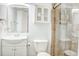 Well-lit bathroom featuring a vanity, toilet, and glass enclosed shower with tiled walls at 2101 S Ocean Blvd. S # B-6, North Myrtle Beach, SC 29582