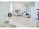 Efficient kitchen featuring a breakfast bar and white appliances, perfect for casual dining and meal prep at 2101 S Ocean Blvd. S # B-6, North Myrtle Beach, SC 29582