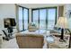 Bright living room features a glass table, floor to ceiling windows and comfortable seating area at 2101 S Ocean Blvd. S # B-6, North Myrtle Beach, SC 29582