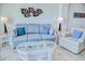 Comfortable living room featuring a plush sofa, wicker furniture, and coastal-themed decor at 2101 S Ocean Blvd. S # B-6, North Myrtle Beach, SC 29582
