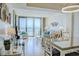 Bright living room featuring floor to ceiling windows and a comfortable sitting area with decor at 2101 S Ocean Blvd. S # B-6, North Myrtle Beach, SC 29582