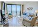 Bright living room featuring floor to ceiling windows and comfortable furniture with great lighting at 2101 S Ocean Blvd. S # B-6, North Myrtle Beach, SC 29582