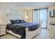 Comfortable main bedroom with a bed, dresser, and a sliding door to the balcony offering ocean views at 2101 S Ocean Blvd. S # B-6, North Myrtle Beach, SC 29582