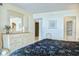 Bright main bedroom with a dresser, mirror, and doorway to the en-suite bathroom at 2101 S Ocean Blvd. S # B-6, North Myrtle Beach, SC 29582