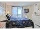 Comfortable main bedroom with a bed, dresser, and a sliding door to the balcony offering ocean views at 2101 S Ocean Blvd. S # B-6, North Myrtle Beach, SC 29582