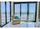 Relaxing seating area showcasing a stunning ocean view through large sliding glass doors at 2101 S Ocean Blvd. S # B-6, North Myrtle Beach, SC 29582