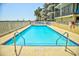 Outdoor pool with clear blue water surrounded by lounge chairs and a white fence offers a relaxing vacation spot at 2101 S Ocean Blvd. S # B-6, North Myrtle Beach, SC 29582