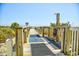 Walkway to the beach featuring a shower and foot washing station so sand doesn't enter the property at 2101 S Ocean Blvd. S # B-6, North Myrtle Beach, SC 29582