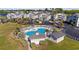 Aerial view of the community pool with ample seating, lounge chairs, and nearby parking at 214 Landing Rd. # I, North Myrtle Beach, SC 29582