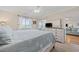 Inviting bedroom featuring a king bed, dresser with TV, and access to the lanai at 214 Landing Rd. # I, North Myrtle Beach, SC 29582