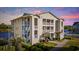 Condominium with nice landscaping, multiple balconies and water view during sunset at 214 Landing Rd. # I, North Myrtle Beach, SC 29582