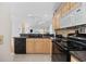Spacious kitchen featuring black appliances and light-colored cabinets at 214 Landing Rd. # I, North Myrtle Beach, SC 29582