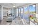 Inviting sunroom features comfortable seating with beautiful waterfront views and tile floors at 214 Landing Rd. # I, North Myrtle Beach, SC 29582