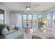 Serene sunroom offers water views, soft seating, and a ceiling fan for comfortable relaxation at 214 Landing Rd. # I, North Myrtle Beach, SC 29582