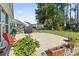 Backyard patio featuring a grill, chair, plants and a view of the fenced-in yard and surrounding houses at 230 Palmetto Green Dr., Longs, SC 29568