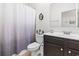 Bathroom featuring a toilet, shower with curtain, dark vanity, and modern decor at 230 Palmetto Green Dr., Longs, SC 29568