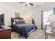 Bedroom featuring a queen bed with a patterned duvet, a wooden headboard, and a vintage-style mirror at 230 Palmetto Green Dr., Longs, SC 29568