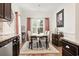 Cozy dining room with natural light, elegant furnishings and an adjacent kitchen at 230 Palmetto Green Dr., Longs, SC 29568