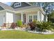 Charming front porch with decorative landscaping and comfortable seating at 230 Palmetto Green Dr., Longs, SC 29568