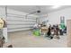 Spacious garage with an open door filled with various stored items at 230 Palmetto Green Dr., Longs, SC 29568