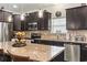 Stylish kitchen with granite island, stainless appliances, and pendant lighting; perfect for entertaining at 230 Palmetto Green Dr., Longs, SC 29568