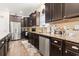 Well-equipped kitchen with dark wood cabinets, stainless steel appliances, and granite countertops at 230 Palmetto Green Dr., Longs, SC 29568
